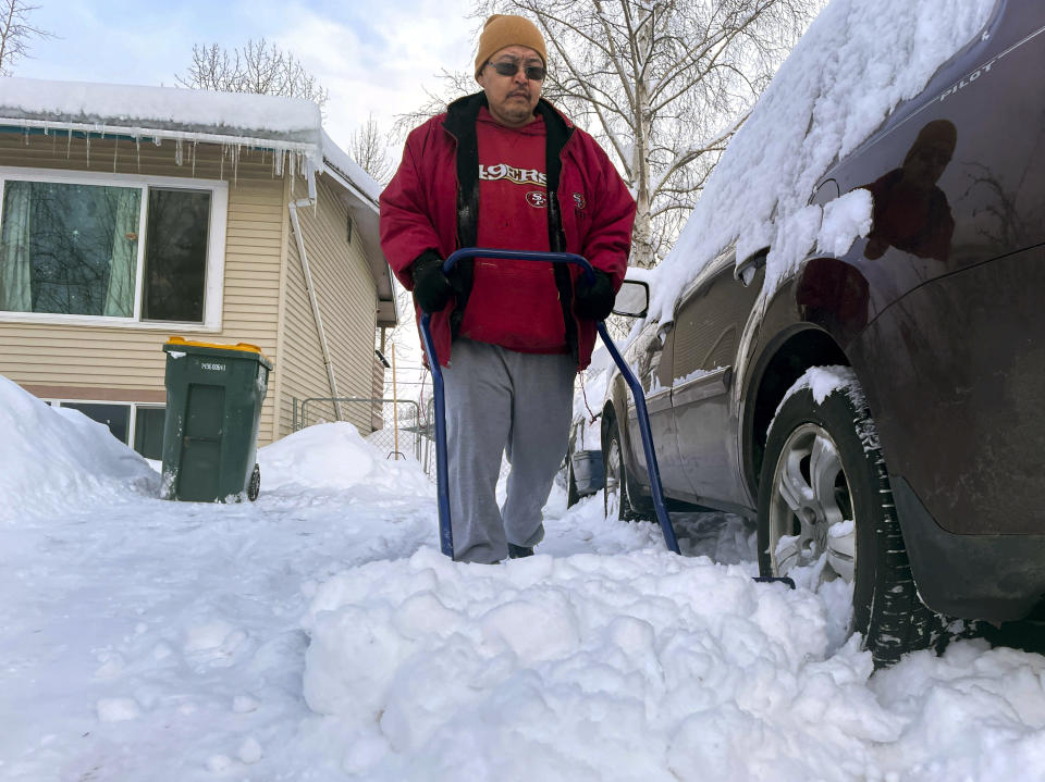 A man who identified himself only as Dale shovels his driveway, Monday, Jan. 29, 2024, in Anchorage, Alaska. (AP Photo/Mark Thiessen)