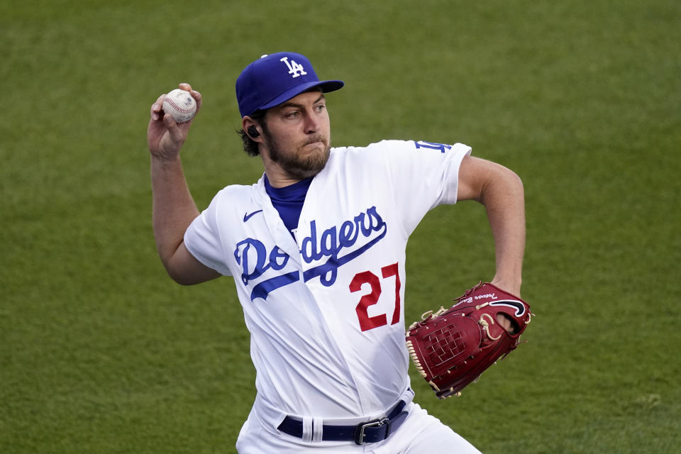 FILE - Los Angeles Dodgers starting pitcher Trevor Bauer warms up prior to a baseball game against the Colorado Rockies, April 13, 2021, in Los Angeles. Bauer was suspended Friday, April 29, 2022, for two full seasons without pay by Major League Baseball for violating the league's domestic violence and sexual assault policy, which he denies. (AP Photo/Mark J. Terrill, File)