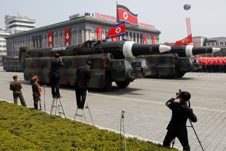 FILE PHOTO: Missiles are driven past the stand with North Korean leader Kim Jong Un and other high ranking officials during a military parade marking the 105th birth anniversary of the country's founding father Kim Il Sung, in Pyongyang April 15, 2017. REUTERS/Damir Sagolj/File Photo