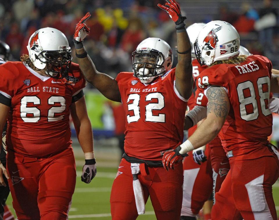 Ball State running back Jahwan Edwards (32) celebrates his fourth touchdown against Arkansas State in the fourth quarter of the GoDaddy Bowl NCAA college football game in Mobile, Ala., Sunday, Jan. 5, 2014. (AP Photo/G.M. Andrews)