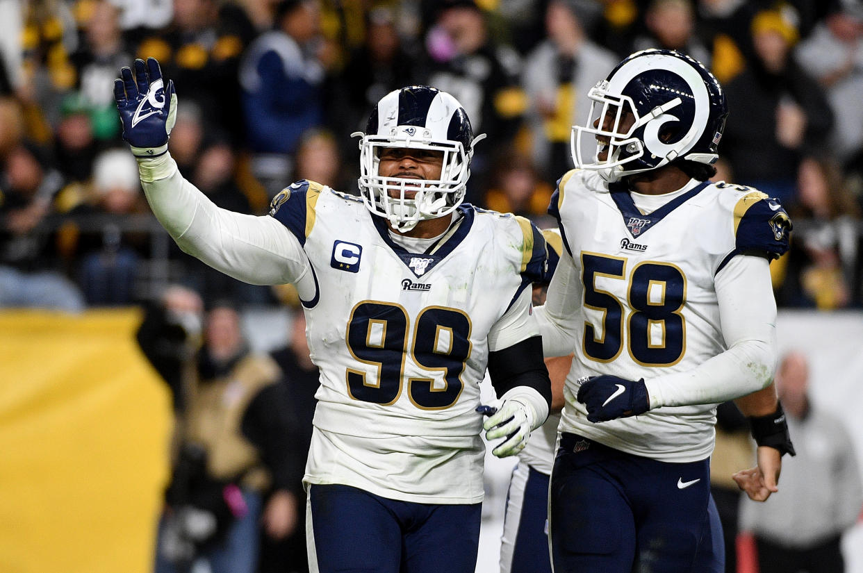 Aaron Donald #99 of the Los Angeles Rams celebrates with Cory Littleton #58 