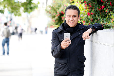 Noe Sanchez shows off the Remitly app that he uses to send money to his family in Mexico in this photo taken in San Francisco, California March 30, 2016. REUTERS/Beck Diefenbach