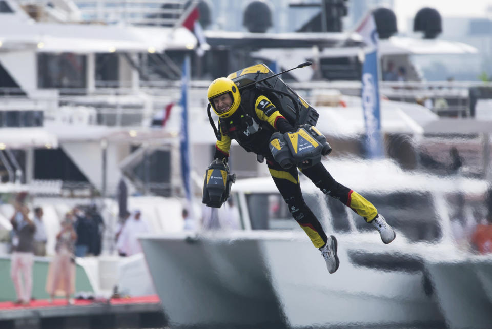 Richard Browning of Gravity Industries races one of his firm's jet suits in Dubai, United Arab Emirates, Wednesday, Feb. 28, 2024. Dubai on Wednesday hosted what it called its first-ever jet suit race. Racers zipped along a route with the skyscrapers of Dubai Marina looming behind them, controlling the jet engines on their hands and their backs. (AP Photo/Jon Gambrell)