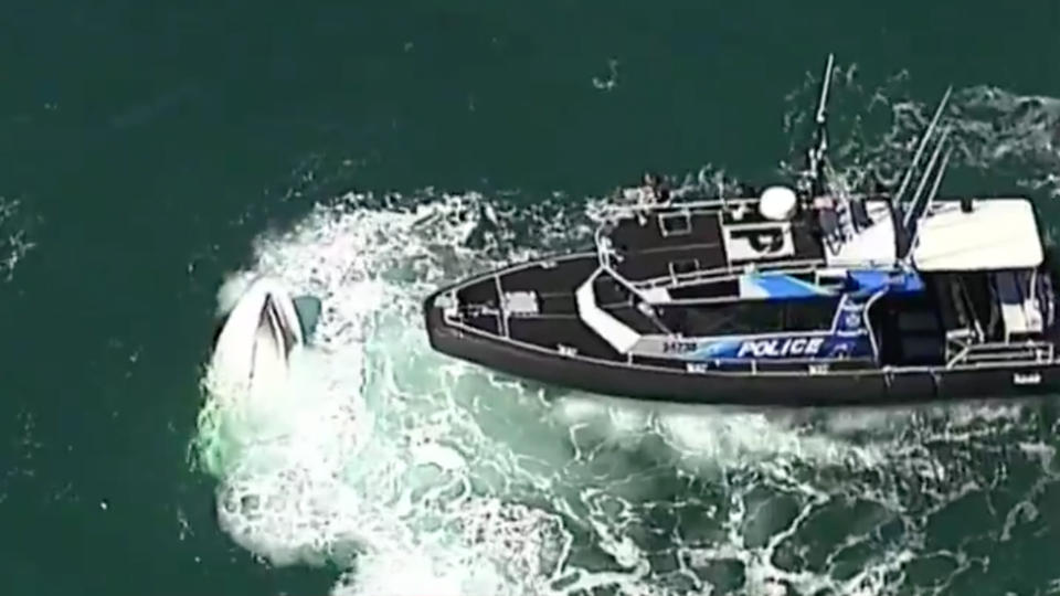 The submerged boat in Moreton Bay with Queensland Police in attendance.