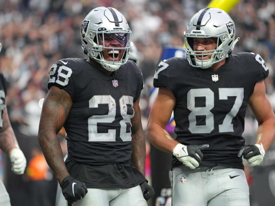 El corredor de los Raiders de Las Vegas, Josh Jacobs (28), celebra con el ala cerrada de los Raiders de Las Vegas, Foster Moreau (87), después de anotar un touchdown contra los Texans de Houston durante la segunda mitad en el estadio Allegiant.