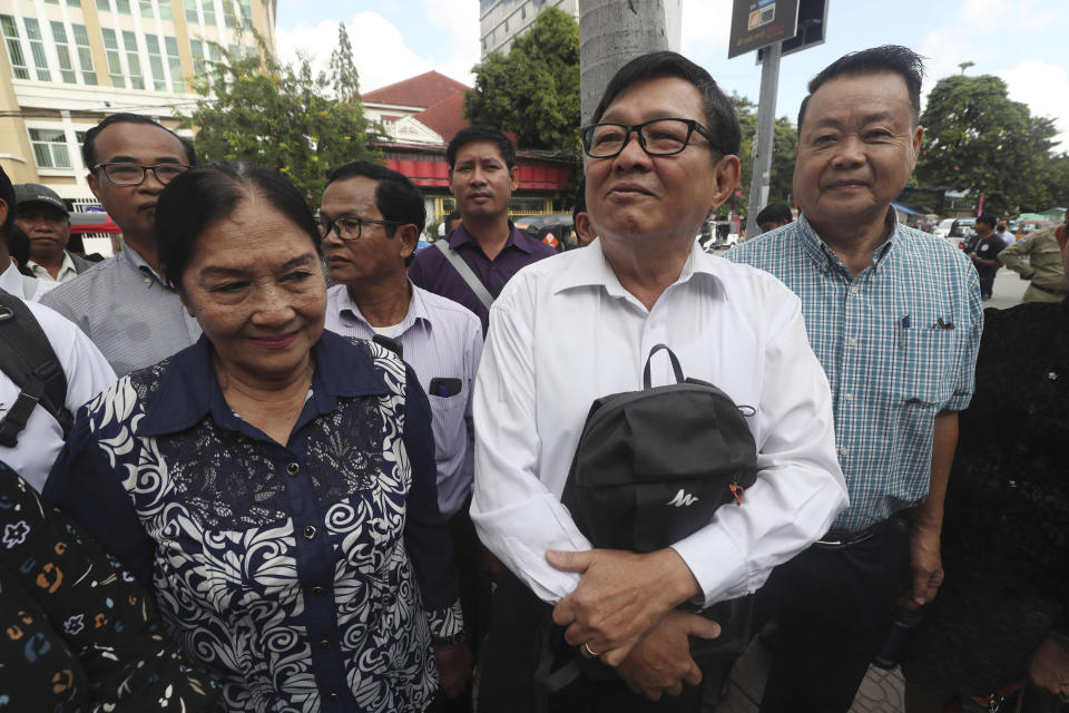 Son Chhay, second from right, deputy leader of the opposition political Candlelight Party, arrives at the Phnom Penh Municipal Court, in Phnom Penh, Cambodia, Friday, Oct. 7, 2022. The court issued a defamation verdict against Son Chhay on Friday in the case filed by NEC. (AP Photo/Heng Sinith)