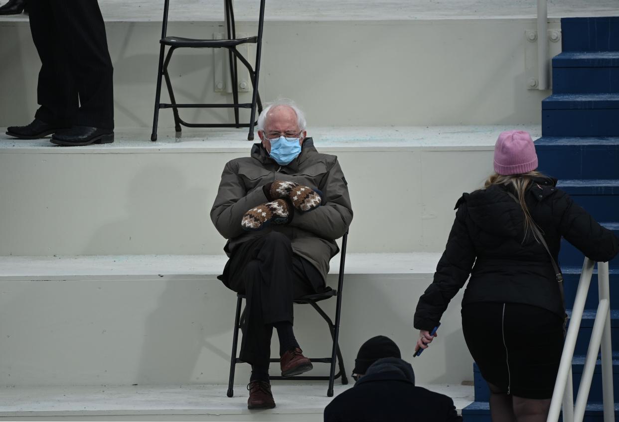 <p>Former presidential candidate, Senator Bernie Sanders (D-Vermont) sits in the bleachers on Capitol Hill before Joe Biden is sworn in as the 46th US President on 20 January 2021, at the US Capitol in Washington, DC</p> ((AFP via Getty Images))