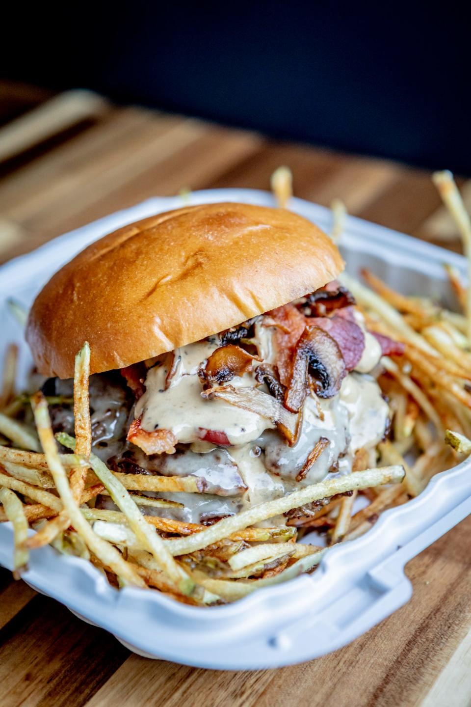 Roam Food Truck makes two kinds of smash burgers —traditional and au poivre, the latter of which comes with bacon, onion, Swiss, cremini mushroom and cognac peppercorn cream.