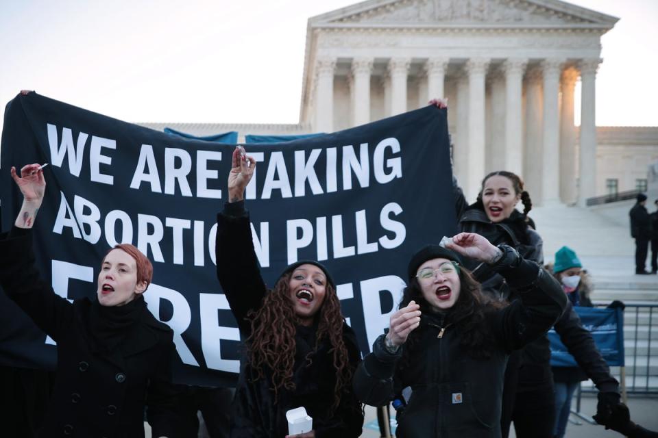 Abortion rights activists took abortion drugs outside the US Supreme Court in December 2021 as justices heard oral arguments in a Mississippi case that could determine the fate of abortion access for millions of Americans. (Getty Images)