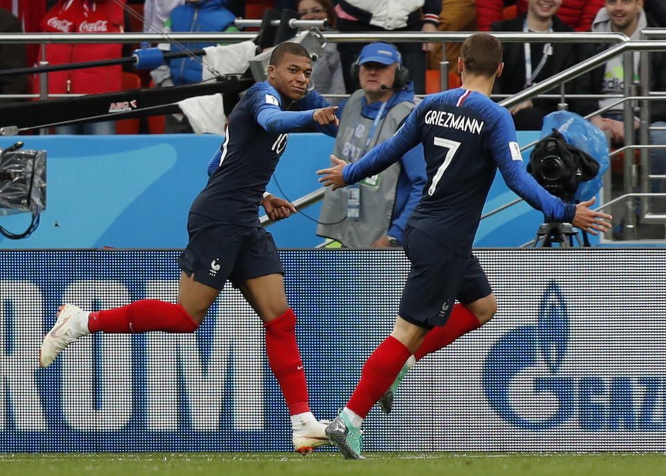 <p>Off the mark: Kylian Mbappe wheels away after scoring his first goal of the tournament. (EFE) </p>