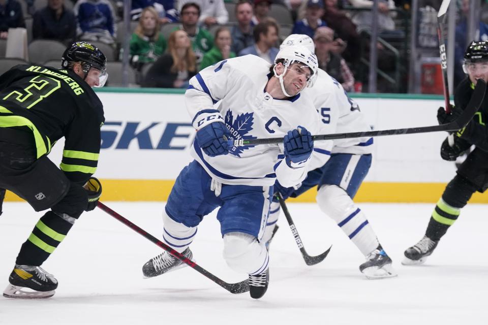 Toronto Maple Leafs center John Tavares (91) falls to the ice after being tripped by Dallas Stars defenseman John Klingberg, left, during the second period of an NHL hockey game Thursday, April 7, 2022, in Dallas. (AP Photo/Tony Gutierrez)