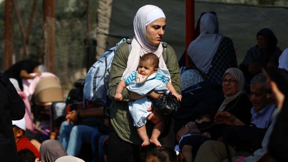 Palestinians with dual citizenship wait outside Rafah border crossing with Egypt. - Ibraheem Abu Mustafa/Reuters
