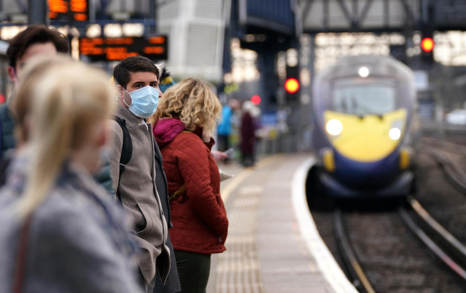 A man waits to board a train at Ashford Railway Station in Kent, as mask wearing on public transport becomes mandatory to contain the spread of the Omicron Covid-19 variant. Picture date: Tuesday November 30, 2021.