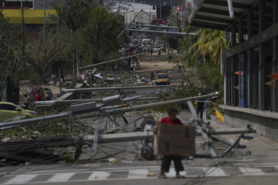Downed power and telephone poles lay on a street after Hurricane Otis ripped through Acapulco, Mexico, Thursday, Oct. 26, 2023. The hurricane that strengthened swiftly before slamming into the coast early Wednesday as a Category 5 storm has killed at least 27 people as it devastated Mexico’s resort city of Acapulco. (AP Photo/Felix Marquez)