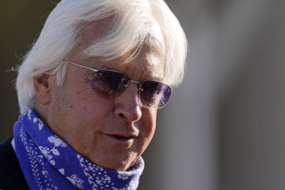 FILE - Bob Baffert, trainer for Kentucky Derby hopeful Medina Spirit, talks to a reporter outside his barn at Churchill Downs Tuesday, April 27, 2021, in Louisville, Ky. Medina Spirit was stripped of the victory in last year’s Kentucky Derby and Mandaloun was declared the winner in a ruling by state racing stewards on Monday, Feb. 21, 2022. (AP Photo/Charlie Riedel, File)