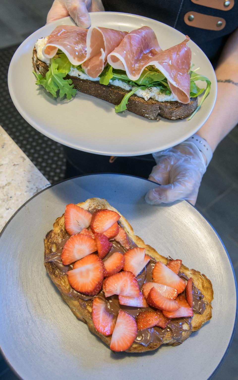 Nutella Toast with strawberries, bottom, and Ricotta Toast with prosciutto, arugula and honey is served up at the new Intuition Coffee + Juice in the Kickapoo Building in downtown Peoria.