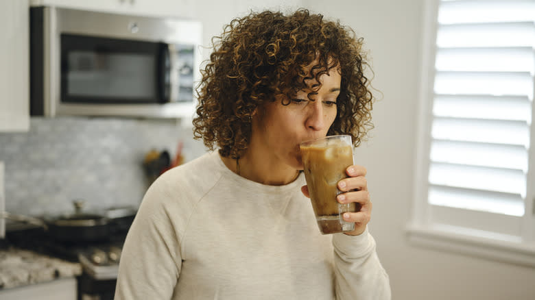 person sipping iced coffee