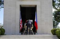 U.S. Secretary of State John Kerry lays a wreath at the Manila American Cemetery in Manila December 17, 2013. The cemetery contains the largest number of graves of U.S. military dead of World War II. (REUTERS/Brian Snyder)