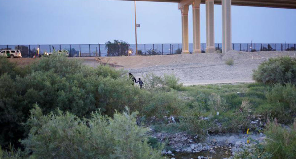 The pair, from Guatemala, are seen here walking towards US Customs and Border Protection jurisdiction.