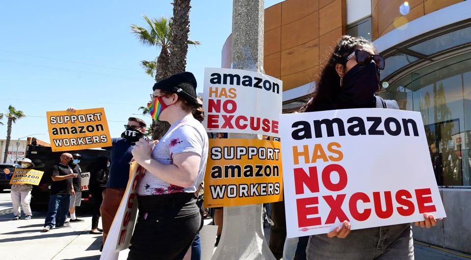 Supporters of Amazon workers protest in front of Fidelity Investments, one of the company's largest shareholders on May 24, 2021 in Santa Monica, California. - The nationwide protests are asking shareholders to demand that Amazon change its practices to be more accountable to workers, communities and stakeholders, while also calling on Amazon to cut ties with US Immigration and Customs Enforcement and end its anti-competitive monopoly practices. (Photo by Frederic J. BROWN / AFP) (Photo by FREDERIC J. BROWN/AFP via Getty Images)