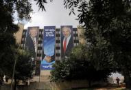 A Likud party election campaign banner depicting Israeli Prime Minister Benjamin Netanyahu shaking hands with U.S. President Donald Trump is seen in Jerusalem