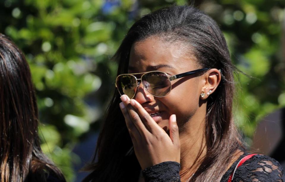 Mourners leave the funeral (AP)