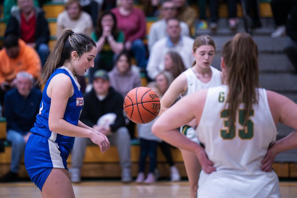 West Boylston's Maddie Pitro spins the ball before the making a free throw for her 1,000th point during the Clinton Holiday Tournament on Friday.