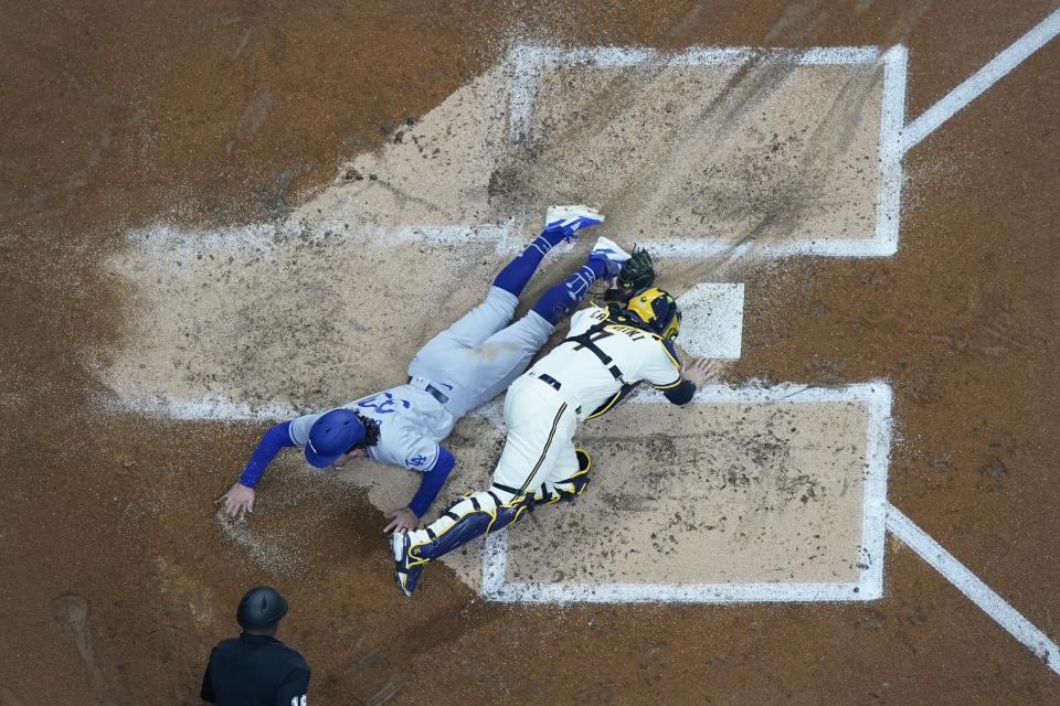 Los Angeles Dodgers' James Outman scores safely past Milwaukee Brewers catcher Victor Caratini during the second inning of a baseball game Tuesday, May 9, 2023, in Milwaukee. Outman scored from second on a hoit by Miguel Rojas. (AP Photo/Morry Gash)