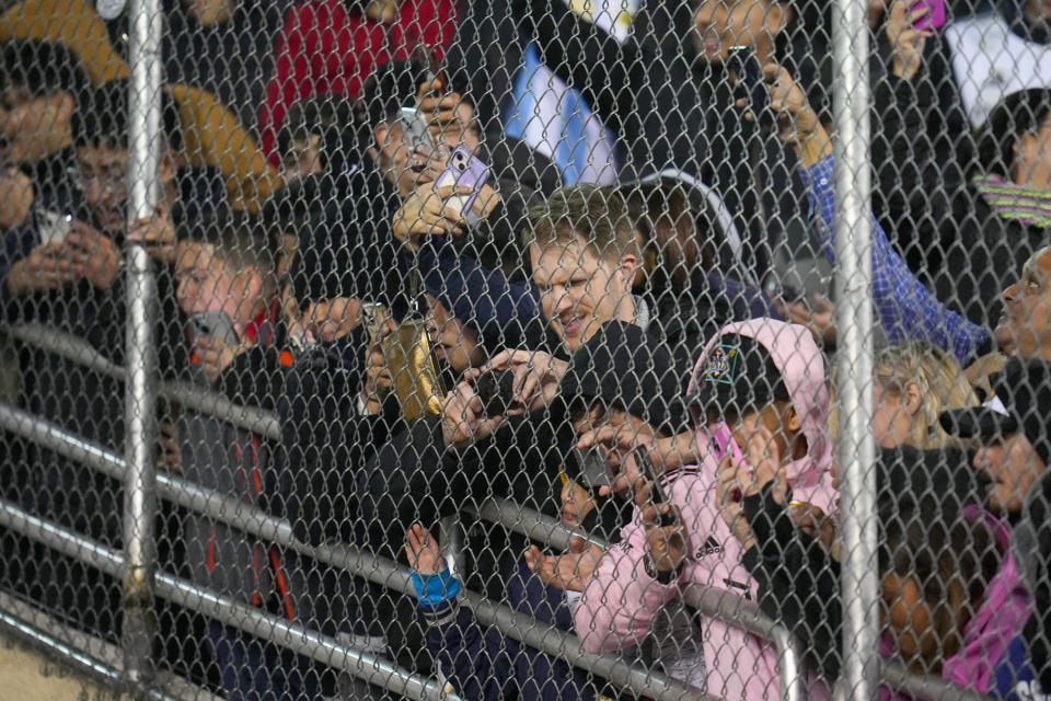 Spectators line a fence while trying to get a look of Inter Miami forward Lionel Messi as he leaves the field during the second half of a preseason friendly MLS soccer match against FC Dallas, Monday, Jan. 22, 2024, at the Cotton Bowl in Dallas. FC Dallas won 1-0. (AP Photo/Julio Cortez)