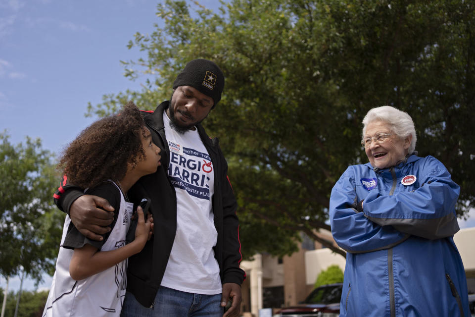 Image: Sergio Harris hugs his son while speaking to supporters. (Danielle Villasana for NBC News)