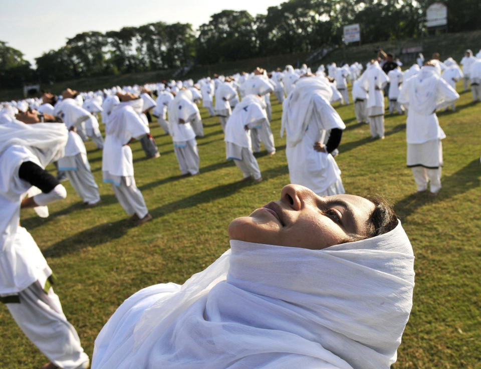 Kashmiri school children perform Yoga on the occasion of the first International Day of Yoga on June 21, 2015 in Jammu, India. An estimated 40,000 people participated in the celebrations at Rajpath, with around two billion people taking part across the world. The yoga celebrations are being organised after the United Nations had in December last year declared June 21 as International Yoga Day. (Waseem Andrabi/Hindustan Times via Getty Images)