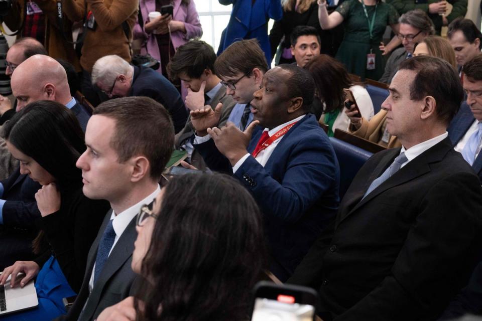 Today News Africa reporter Simon Ateba, centre, interrupts Karine Jean-Pierre during the White House daily press briefing (AFP via Getty Images)