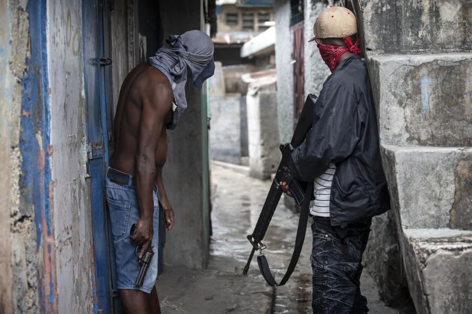 Gang members stand guard and hold guns six months after a massacre in the La Saline slum of Port-au-Prince, Haiti, May 31, 2019. "Gangs are multiplying because the government is weak," said Paul Eronce Villard, Haiti's general prosecutor, who estimates there are more than 50 gangs now operating in the country. "It's a real challenge for police." The image was part of a series of photographs by Associated Press photographers which was named a finalist for the 2020 Pulitzer Prize for Breaking News Photography. (AP Photo/Dieu Nalio Chery)