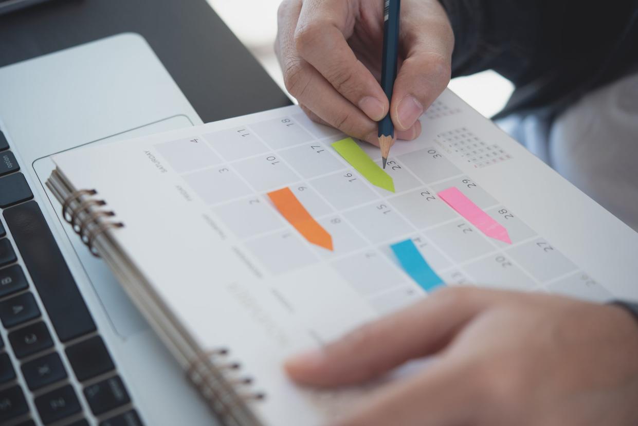 2024 Calendar event planning timetable agenda plan on organize schedule. Event planner agenda organizing by organizer schedule. Business man hand note on notebook with calendar planner on office table