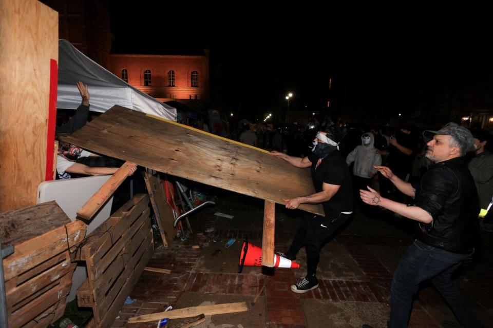 PHOTO: Counter-protesters attack protesters pro-Palestinian protesters in an encampment on the campus of the University of California, Los Angeles (UCLA), May 1, 2024, in Los Angeles.  (David Swanson/Reuters)