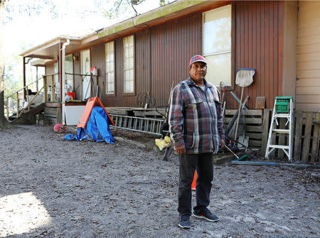 Alfredo Becerra, whose home was damaged by flooding during Hurricane Harvey, is pictured in Patton Village, Texas, U.S., December 9, 2017. REUTERS/Trish Badger