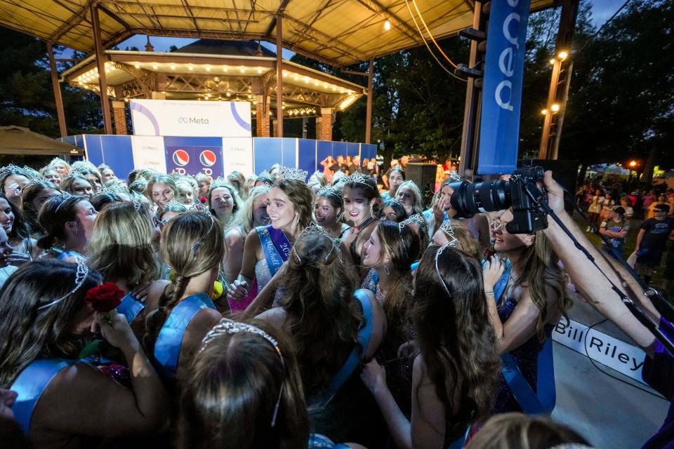 Mitchell County's Mary Ann Fox is surrounded by the other contestants after she was crowned the 2022 Iowa State Fair queen Saturday in Des Moines.