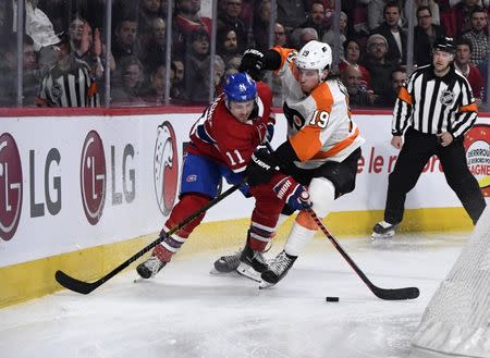 Feb 21, 2019; Montreal, Quebec, CAN; Montreal Canadiens forward Brendan Gallagher (11) battles for the puck with Philadelphia Flyers forward Nolan Patrick (19) during the second period at the Bell Centre. Mandatory Credit: Eric Bolte-USA TODAY Sports