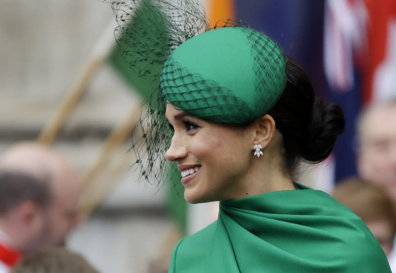 A woman wearing a green hat and dress