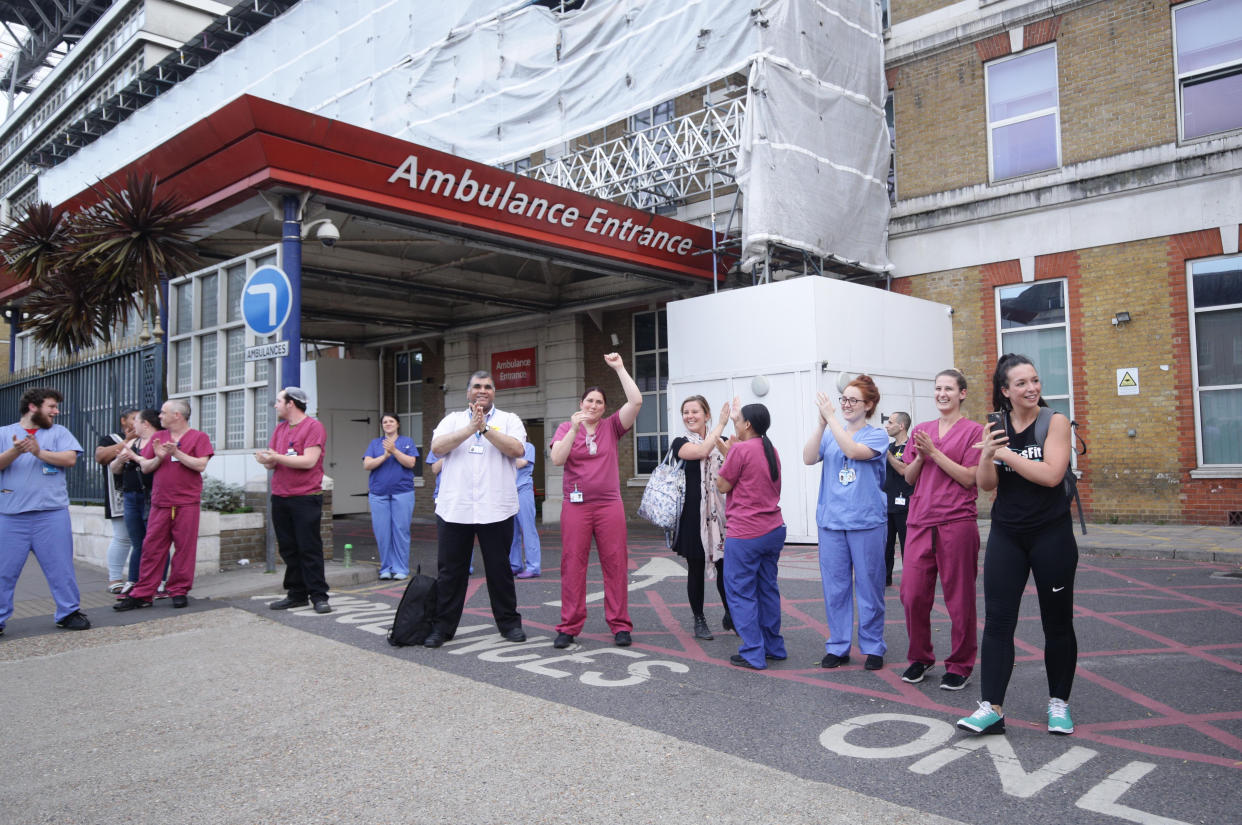 NHS staff outside King's College Hospital in Camberwell, south London, join in the applause to salute local heroes during Thursday's nationwide Clap for Carers to recognise and support NHS workers and carers fighting the coronavirus pandemic.