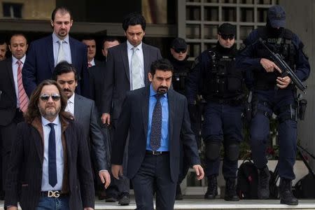 The eight Turkish soldiers, who fled to Greece in a helicopter and requested political asylum after a failed military coup against the government, are escorted by police officers as they leave the Supreme Court in Athens, Greece, January 23, 2017. REUTERS/Alkis Konstantinidis