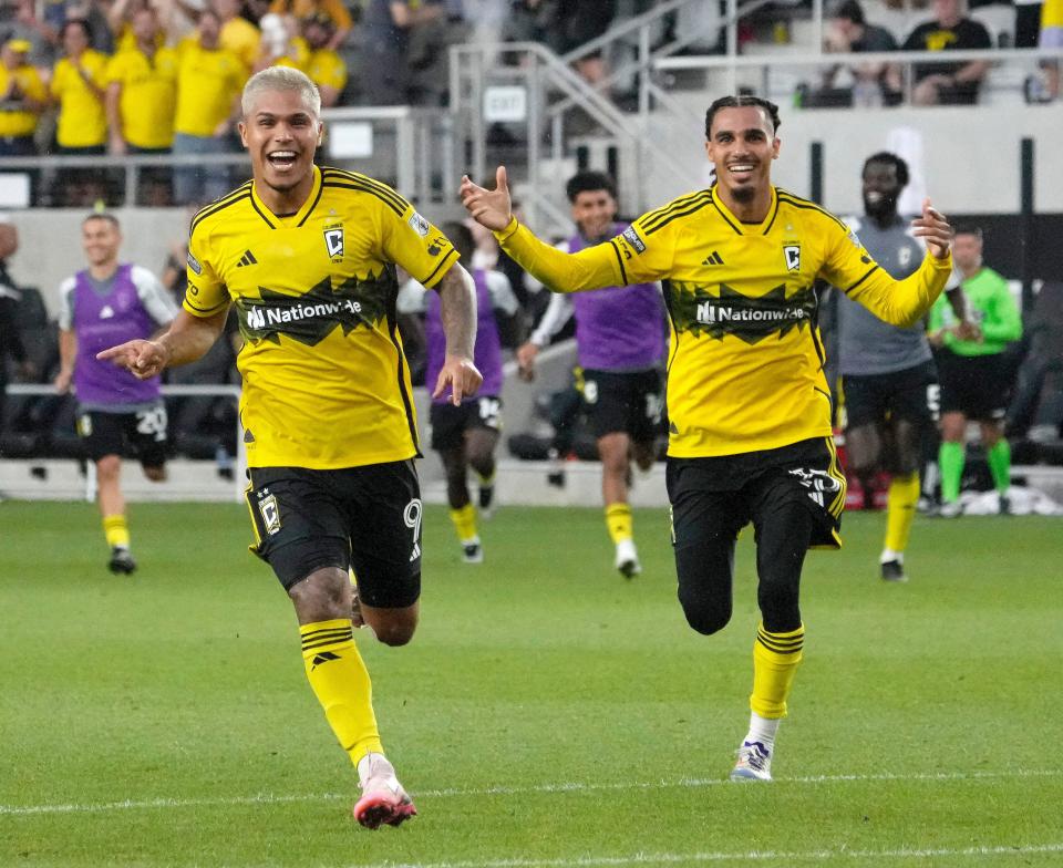 August 17, 2024; Columbus, Ohio, USA; 
Columbus Crew forward Cucho Hernandez (9) and Columbus Crew defender Mohamed Farsi (23) run to celebrate a win against New York City FC on penalty kicks in a Leagues Cup quarterfinal match at Lower.com Field.