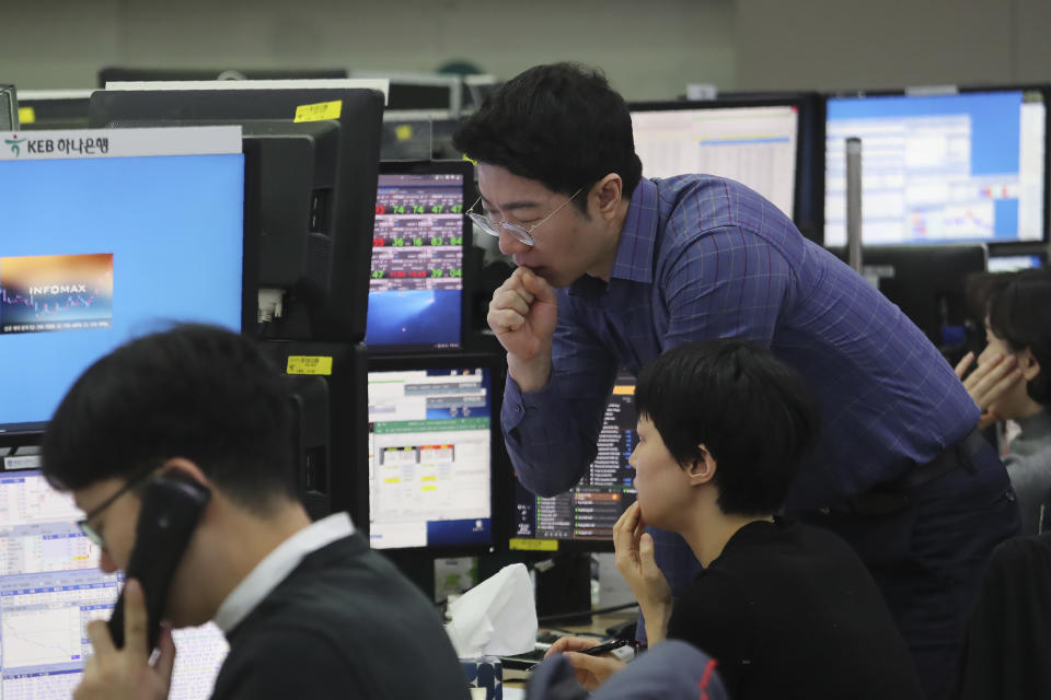 Currency traders watch monitors at the foreign exchange dealing room of the KEB Hana Bank headquarters in Seoul, South Korea, Friday, Jan. 3, 2020. Asian stocks were mixed Friday and oil prices surged after an Iranian general was killed by U.S. forces in Iraq. (AP Photo/Ahn Young-joon)