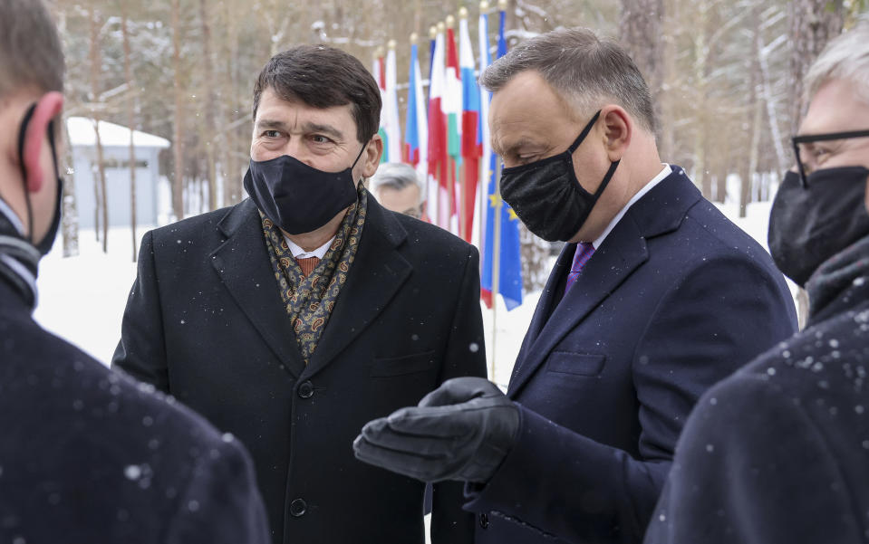 Poland's President Andrzej Duda chats to welcome Hungary's President Janos Ader for a two-day summit with the presidents of Hungary and The Czech Republic marking 30 years of the Visegrad Group, an informal body of political and economic cooperation in the region, at the presidential residence in the Hel Peninsula, Poland, on Tuesday, Feb. 9, 2021.(Jakub Szymczuk / KPRP via AP )