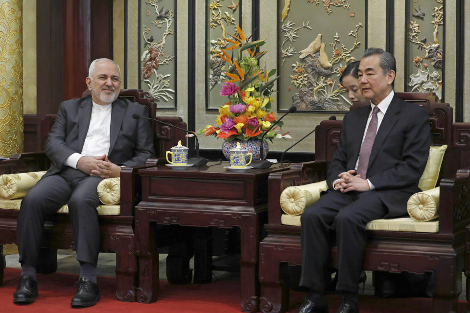 Iranian Foreign Minister Mohammad Javad Zarif, left, and his Chinese counterpart Wang Yi, right, talk during their meeting at the Diaoyutai State Guesthouse in Beijing, China, Tuesday, Feb. 19, 2019. The foreign ministers of China and Iran met in Beijing on Tuesday amid efforts to preserve the 2015 nuclear deal with Tehran.(How Hwee Young/Pool Photo via AP)