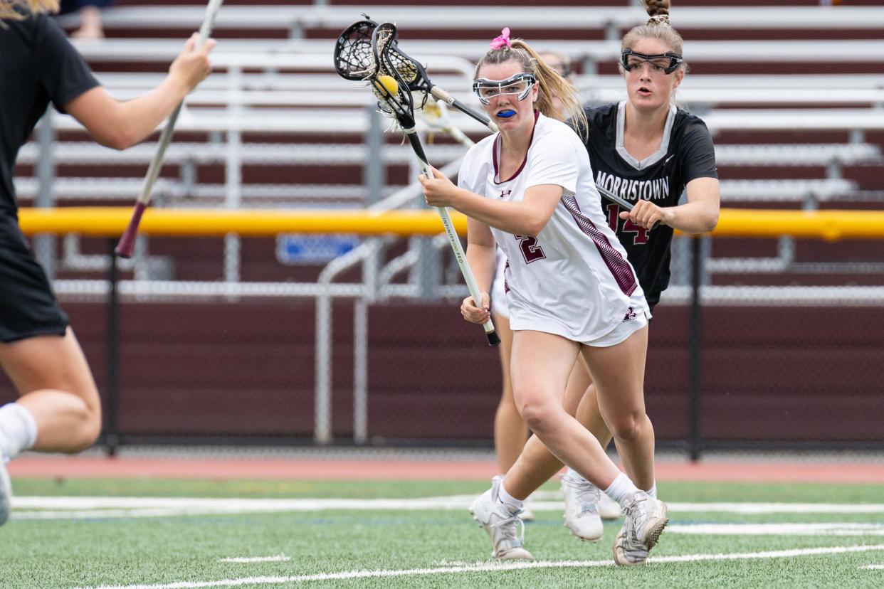 Jun 5, 2023; Ridgewood, New Jersey, USA; Ridgewood Emme Dunphey (2) moves the ball up field against Morristown during the North Group 4 girls lacrosse final at Ridgewood High School. Mandatory Credit: Tom Salus-The Record