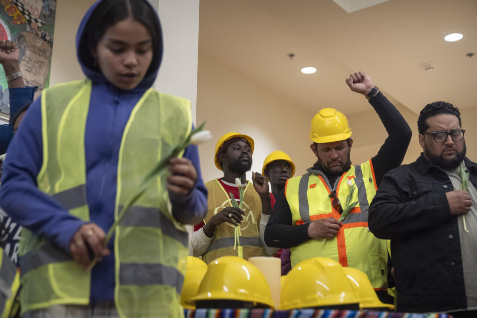 Construction workers and supporters reflect during a moment of prayer at a vigil and press conference by CASA of Maryland, a community advocacy group, to remember the six workers killed in the collapse of the Francis Scott Key Bridge and to highlight the difficult conditions faced by immigrant construction workers on Friday, March 29, 2024, in Baltimore, Md. (AP Photo/Mark Schiefelbein)