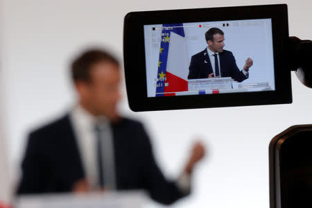 French President Emmanuel Macron is seen on a video camera screen as he delivers a speech on security to representatives of French national police, gendarmes and "Sentinelle" security plan soldiers at the Elysee Palace in Paris, France, October 18, 2017. REUTERS/Philippe Wojazer