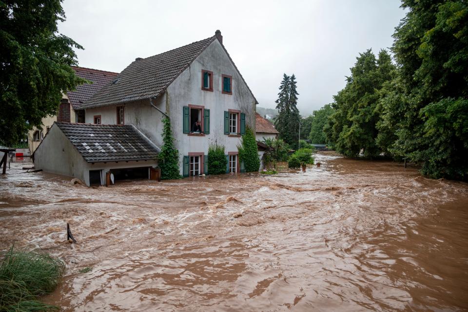 Houses are submerged by the overflowing river banks in Erdorf, Rhineland-Palatinate (AP)