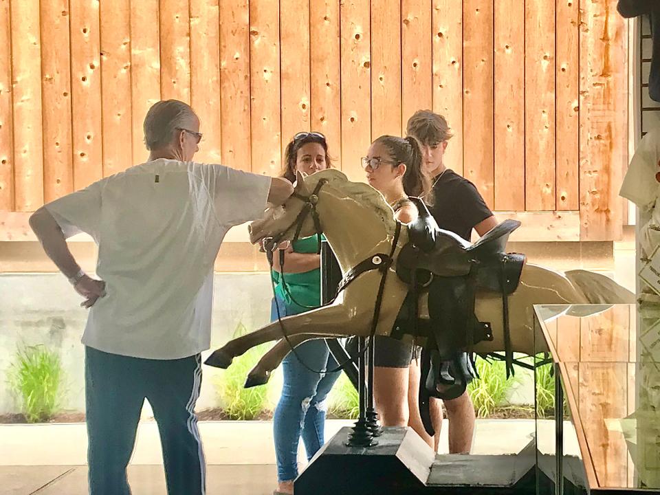 Some people appreciate Champion the Wonder Horse's charms in different ways. This visitor used the kiddie ride at Funland in Rehoboth Beach as a leaning post. 8/1/2023